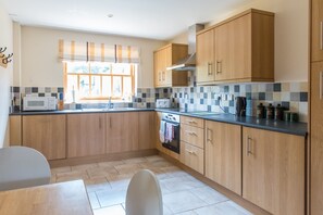 Fully fitted kitchen with oven, hob, dishwasher, fridge and freezer
