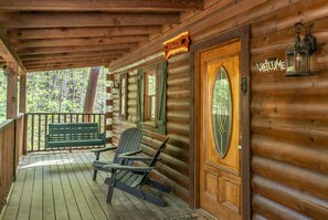 Front porch with swing and three Adirondack chairs