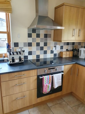 Fully fitted kitchen with oven, hob, dishwasher, fridge and freezer