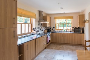 Fully fitted kitchen with oven, hob, dishwasher, fridge and freezer