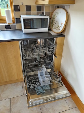 Fully fitted kitchen with oven, hob, dishwasher, fridge and freezer