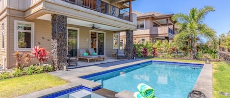 Private pool, jacuzzi and tropically landscaped garden appoint the backyard of this elegant split-level home.