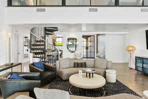 Main house living space. Spiral staircase leads to loft.