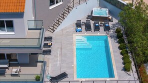 Private 32msq pool with 7 comfortable lounge chairs, and whirlpool
