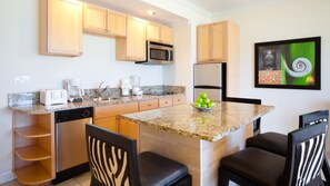 VIEW OF KITCHEN WITH ALL UNTENSILS AND POTS AND PANS, REFRIGERATOR , STOVE/MICRO