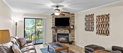 Bright & Clean Living Room has wood-burning fireplace and views of the lake. 