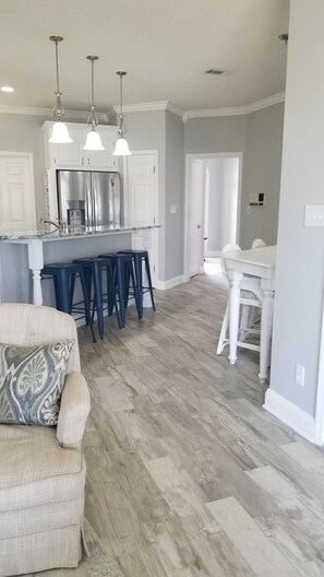 Den, kitchen, and breakfast table. Open floor plan with views of the water. 