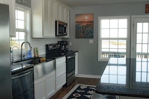 Kitchen with everything you need (Microwave, air fryer, coffee maker, toaster).