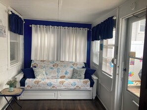 Front room opens to full bed across fromTV