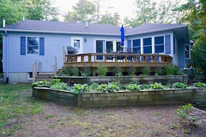 The large deck has a Weber grill and a garden with fresh herbs.