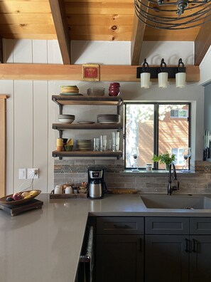 Open shelving in kitchen for quick access to everyday items.