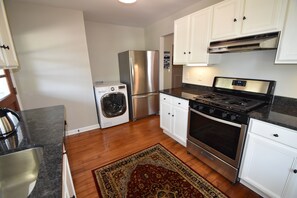 Kitchen - washer/dryer combo, gas range, venthood, fridge with icemaker