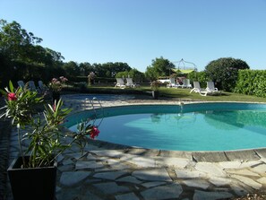 Pool area with heated pool in the background