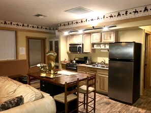 View of kitchen with island style dining table and chairs 