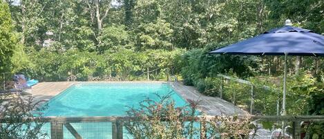 20 x 40 heated pool with umbrellas and lounge chairs and floats