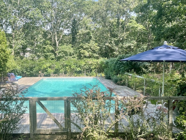 20 x 40 heated pool with umbrellas and lounge chairs and floats