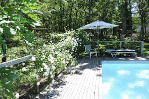 Roses by heated pool, umbrellas and lounge chairs