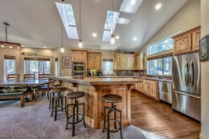 This gourmet kitchen with stainless steel appliances and granite countertops has plenty of space for any helping hands