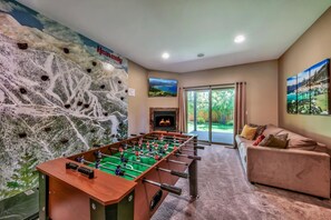 The kids will love this one of a kind custom built Heavenly Mountain rock climbing wall and foosball table! Located in the downstairs living space