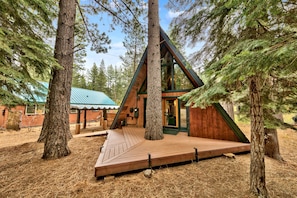 Beautiful deck on the front of the house with inset tree.