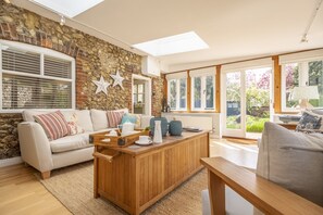 The Old Dairy, Great Bircham: The sitting room leads through into the garden room