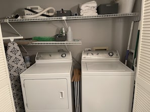 Condo has washer, dryer, iron and ironing board as well as mop and broom.  
