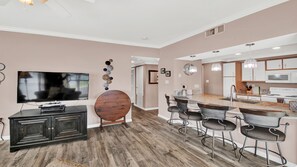 Flat screen television and folding table for dining.