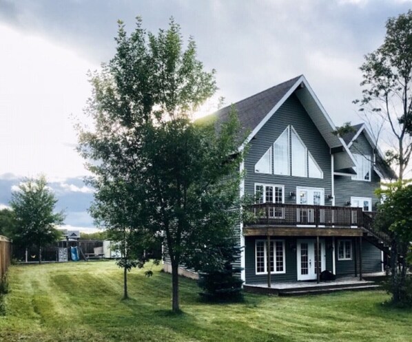 Front view of Fortnight Chalet and garden/playground view in the rear.