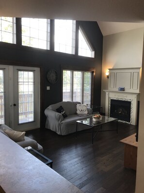 Living Room area with front deck access and fireplace.