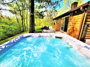 Relax & Unwind in the Hot Tub, While the Forest Behind You & the String Lighting Add to Ambiance
