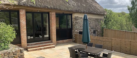 Enclosed patio garden with patio doors and steps down from living room