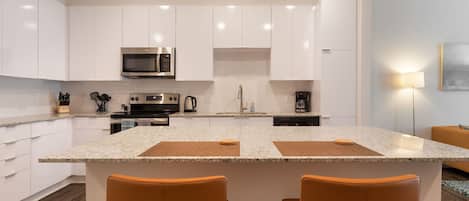 Fully Equipped Kitchen with Island Bar Seating - BCA Furnished Apartments - 1-Bedroom Spectacular Suites