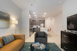 Contemporary Open Kitchen and Living Room - Corporate Apartments Near Me - 1-Bedroom Spectacular Suites