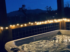 Enjoy an evening soak in the hot tub with views of the village below. 
