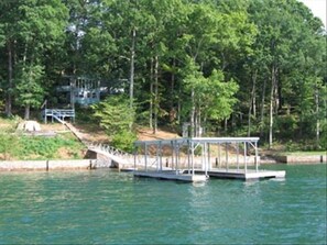 covered dock with boat slip and swim platform