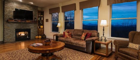 A wall of windows in the living room offers beautiful long range views. 