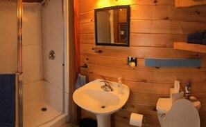 Full bathroom with large shower stall.  knotty pine and hardwood floors