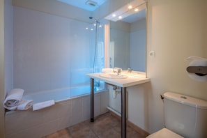 This bathroom features a shower and tub combination.