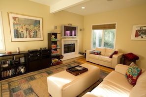 TV Room and Den with fireplace and white leather couches