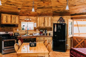 Kitchen & Dining Area with Range/Oven, Roll-under sink, Refrigerator and Dining Table with Chairs.