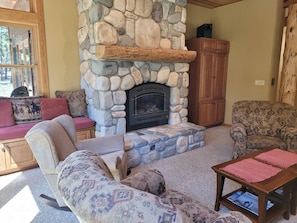 Enjoy relaxing by a fire in this river rock gas fireplace. 