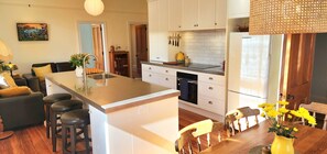 Open plan, spacious dinning, kitchen, lounge with new European appliances.