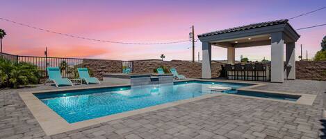 Pool and outdoor kitchen at sunset