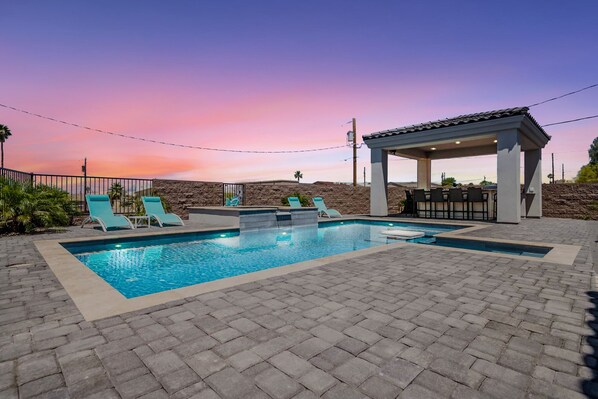 Pool and outdoor kitchen at sunset