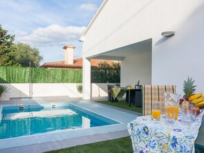 Furnished terrace and pool at night