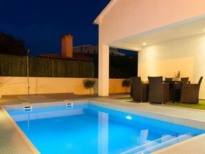 Furnished terrace and pool at night