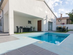 Furnished terrace and pool at night