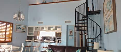 View from Living Room to the Kitchen and upstairs Bedroom. 