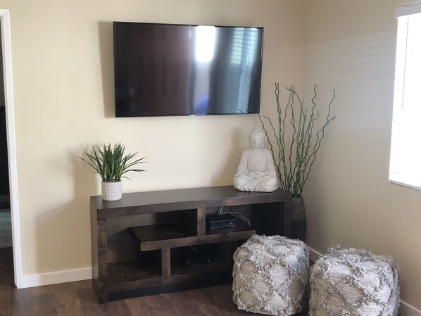 Mounted Smart Tv in living room with Netflix and various apps