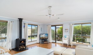 Light & bright living area with cosy fireplace